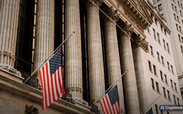 The columned facade of the New York Stock Exchange with American flags
