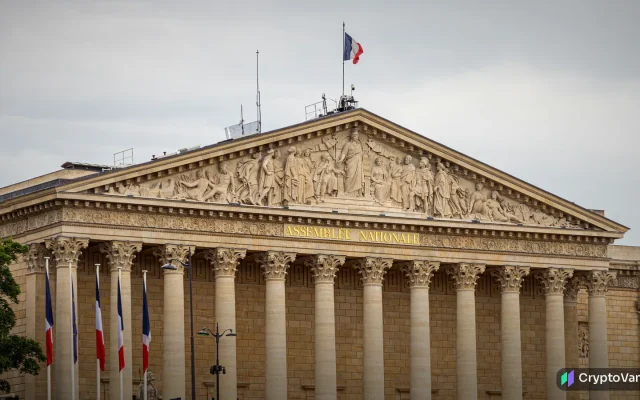 France crypto tax: the Palais Bourbon, home of the French National Assembly, with French flags in front of its columns