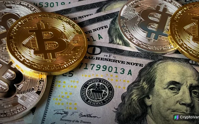 Gold bitcoin coins scattered on top of U.S. hundred-dollar bills