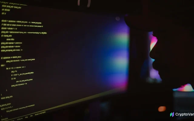 Lines of code glowing on a computer monitor in a dark room