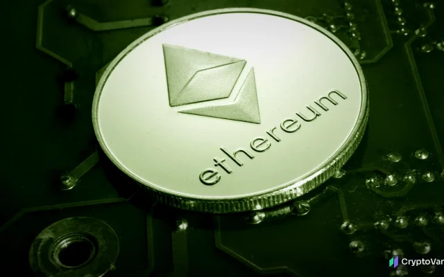 A silver coin stamped with the ethereum symbol lying on a green circuit board