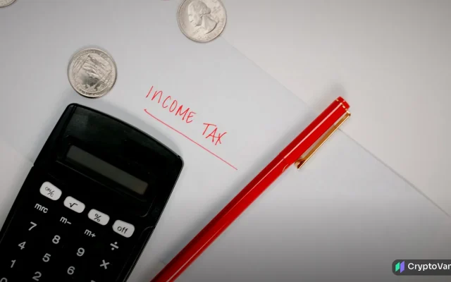 Calculator, red pen and an income tax note, illustrating crypto taxes